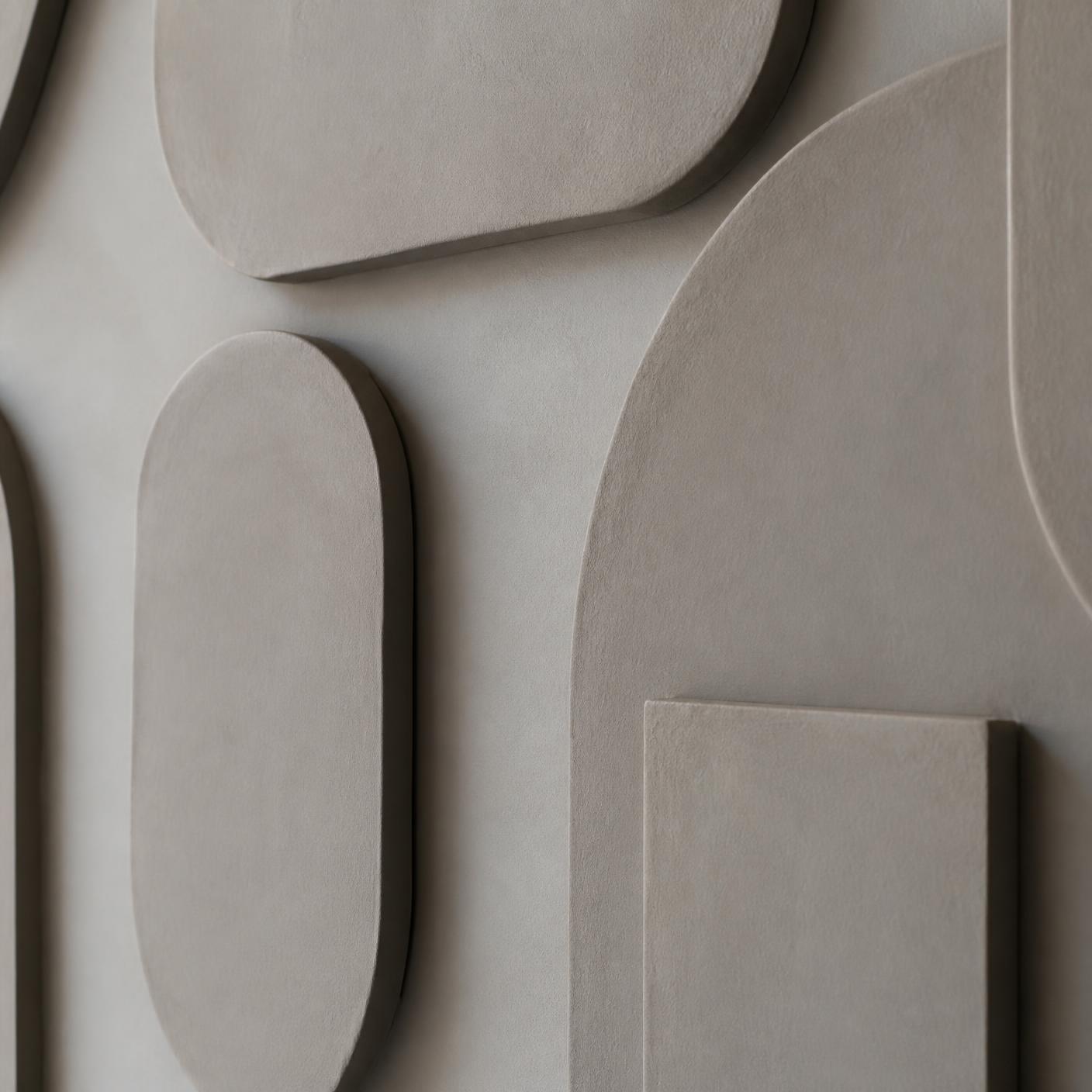 Macro view of unbranded dimensional forms on an interior wall showing edges, depth, and soft shadow